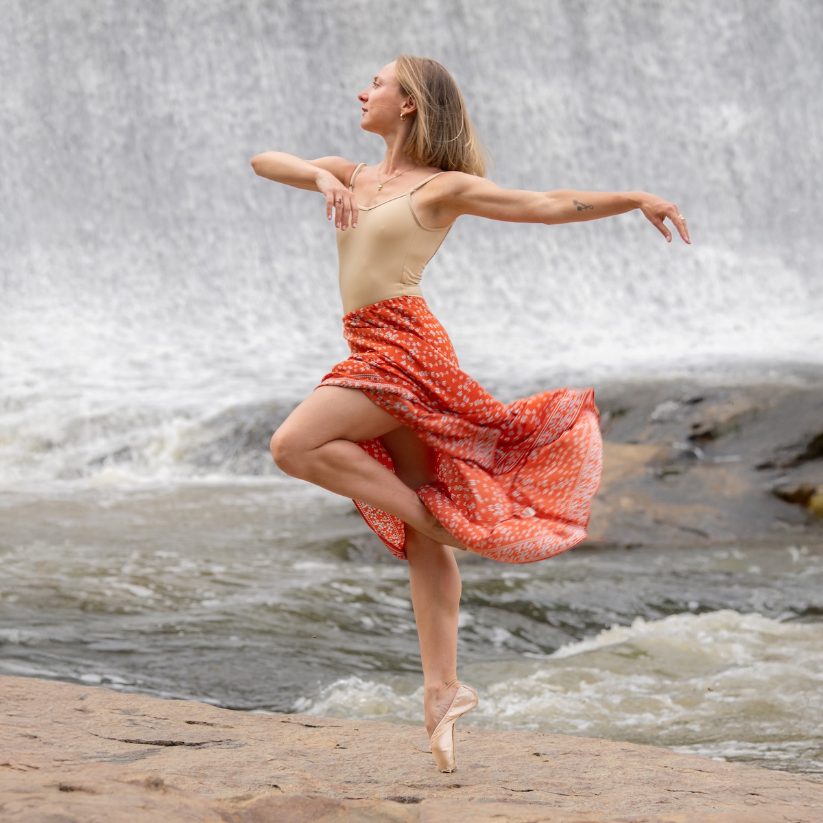 Amy Dancing in front of waterfall