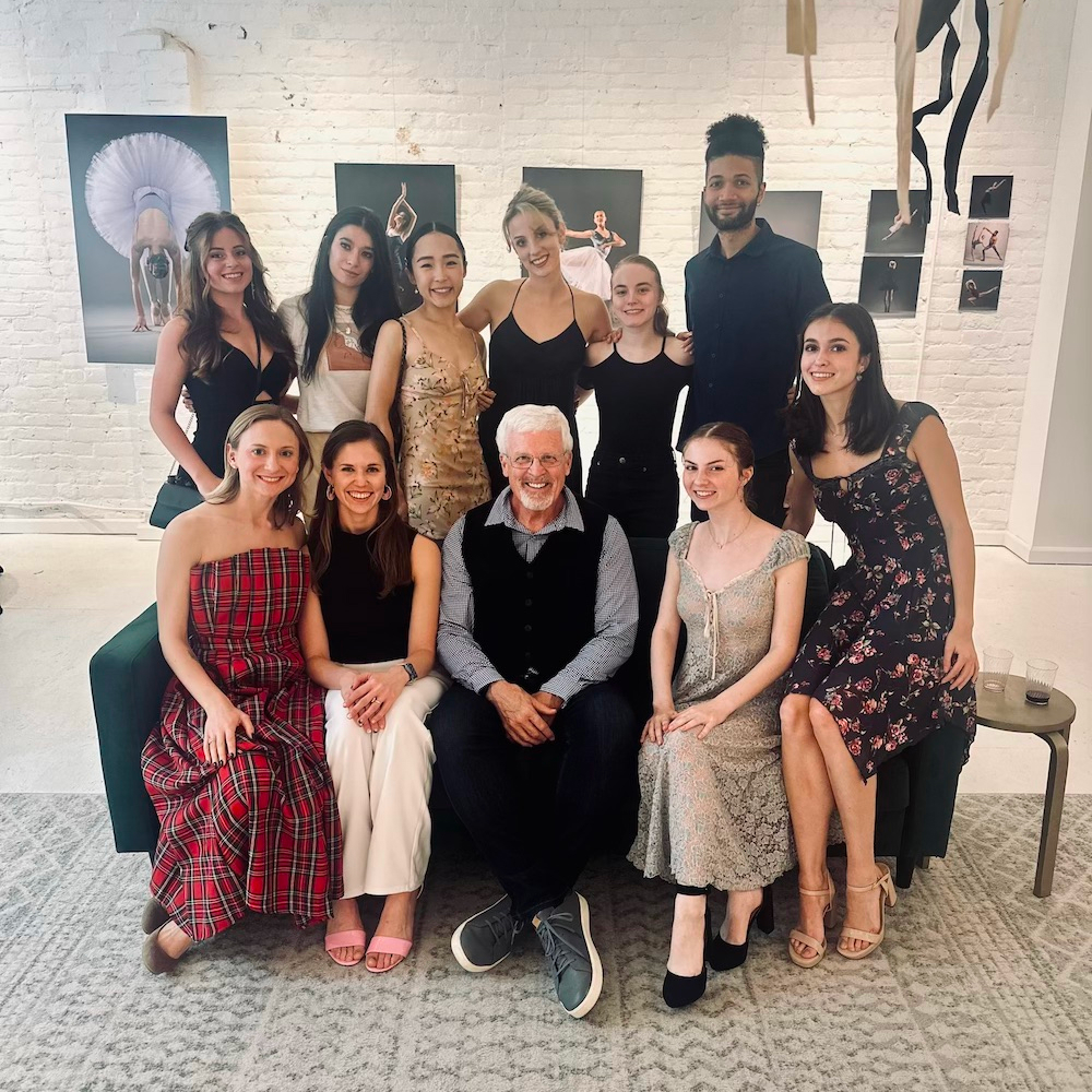 Mike Ethridge posing for a group photo with the subjects of his photography series focused on dancers